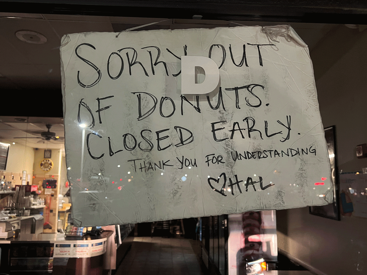 picture of sign on donut shot that says 'donut shop closed early'